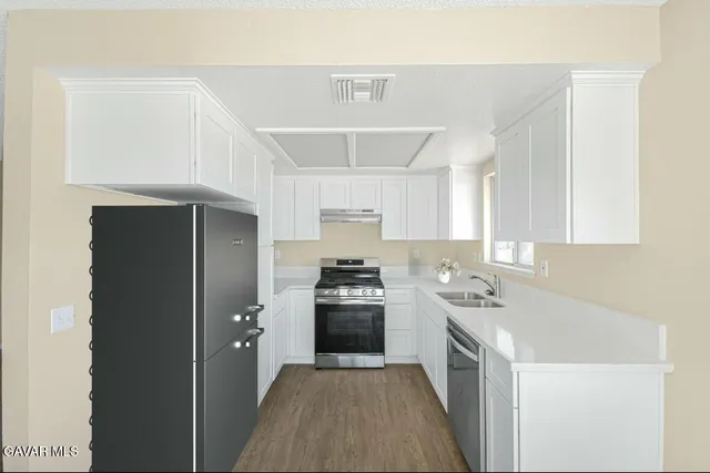 a kitchen with a stove and a refrigerator