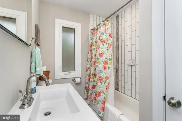 a bathroom with a granite countertop sink toilet and a mirror