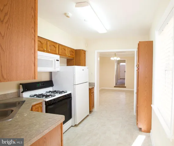 a kitchen with stainless steel appliances a refrigerator a stove and a sink