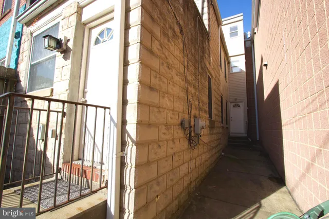a view of a brick wall with a window and outside view