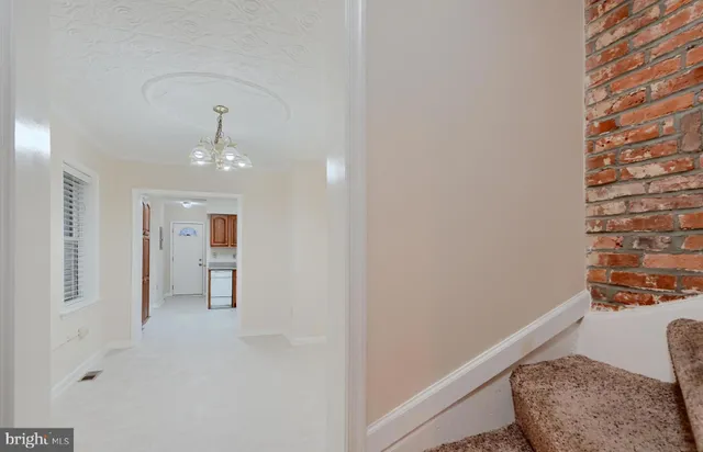 a backyard of a house with two chairs and wooden floor