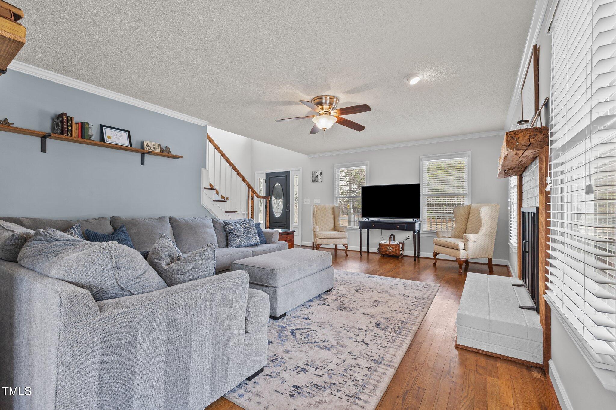3068 Benson Road Angier, NC 27501 - Photo 6 of 52 a living room with furniture and a flat screen tv