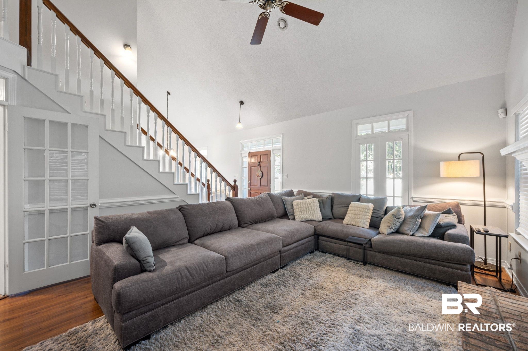 6705 Autumn Ridge Drive Mobile, AL 36695 - Photo 7 of 24 Living room with ceiling fan, dark hardwood / wood-style flooring, and high vaulted ceiling