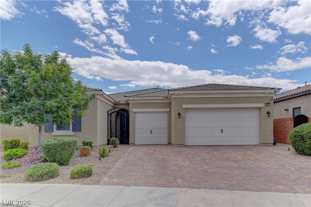 5967 Yellow Ridge Avenue Las Vegas, NV 89131 - Photo 1 of 33 This residence features a paver driveway, an inviting entrance, and well-maintained landscaping.