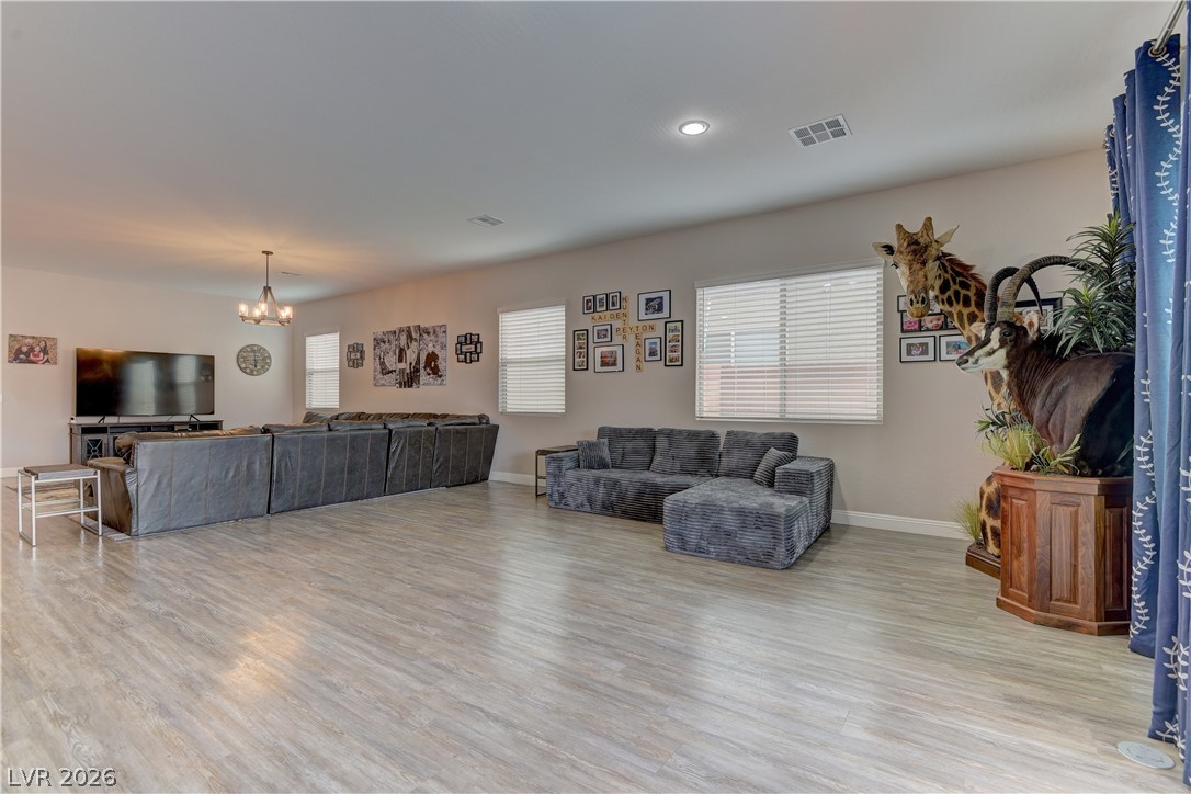 5967 Yellow Ridge Avenue Las Vegas, NV 89131 - Photo 11 of 33 This living room features ample space for gatherings with bright windows and sleek flooring.