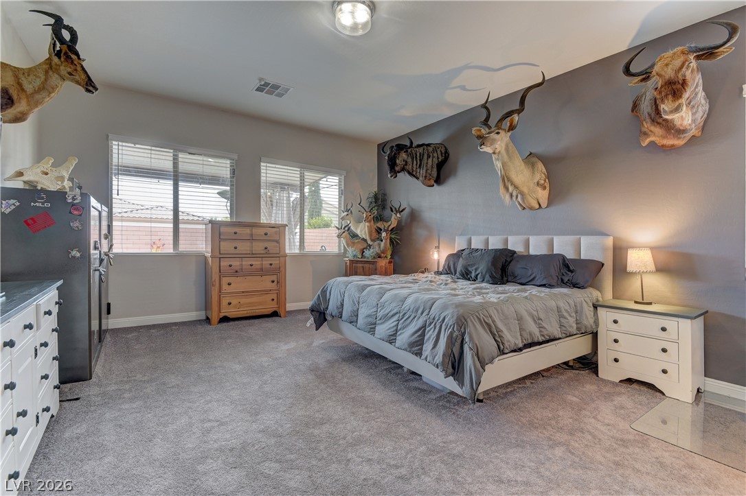 5967 Yellow Ridge Avenue Las Vegas, NV 89131 - Photo 12 of 33 This spacious bedroom offers ample natural light and a serene retreat, ideal for peaceful slumber.