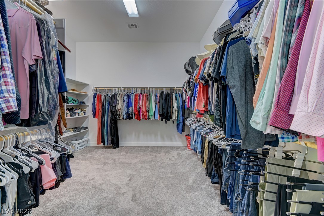 5967 Yellow Ridge Avenue Las Vegas, NV 89131 - Photo 18 of 33 This spacious closet offers ample storage with convenient hanging rods and built-in shelving.