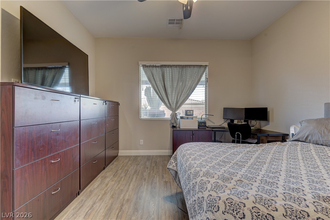 5967 Yellow Ridge Avenue Las Vegas, NV 89131 - Photo 20 of 33 This spacious bedroom offers comfortable living with durable flooring and ample natural light.
