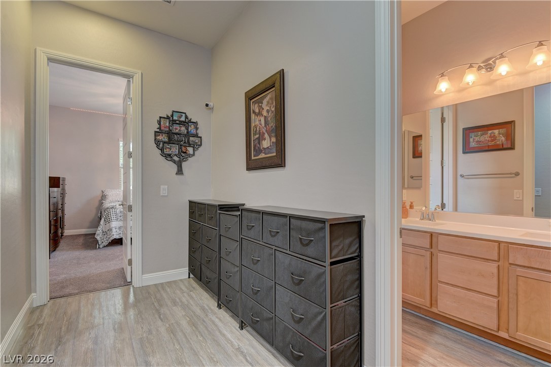 5967 Yellow Ridge Avenue Las Vegas, NV 89131 - Photo 23 of 33 This spacious hallway connects rooms with sleek flooring and ample storage.