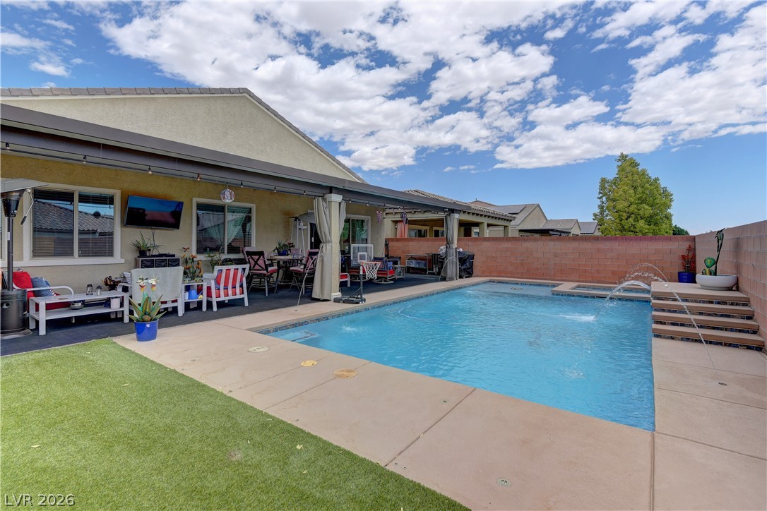 5967 Yellow Ridge Avenue Las Vegas, NV 89131 - Photo 31 of 33 Enjoy outdoor living with a sparkling pool and covered patio for relaxation and entertainment.