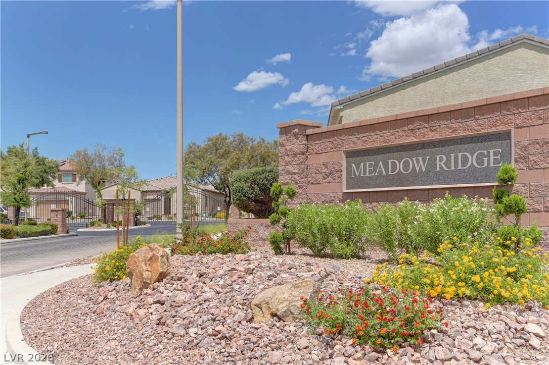 5967 Yellow Ridge Avenue Las Vegas, NV 89131 - Photo 32 of 33 Welcome to Meadow Ridge, a community entrance marked by elegant stone and vibrant landscaping.