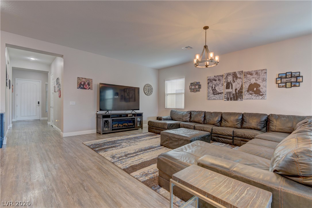 5967 Yellow Ridge Avenue Las Vegas, NV 89131 - Photo 4 of 33 This inviting living area boasts sleek flooring and ample natural light, perfect for everyday living.