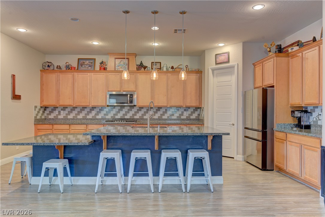 5967 Yellow Ridge Avenue Las Vegas, NV 89131 - Photo 6 of 33 Bright, open-concept kitchen features a spacious island and ample cabinetry, perfect for culinary endeavors.