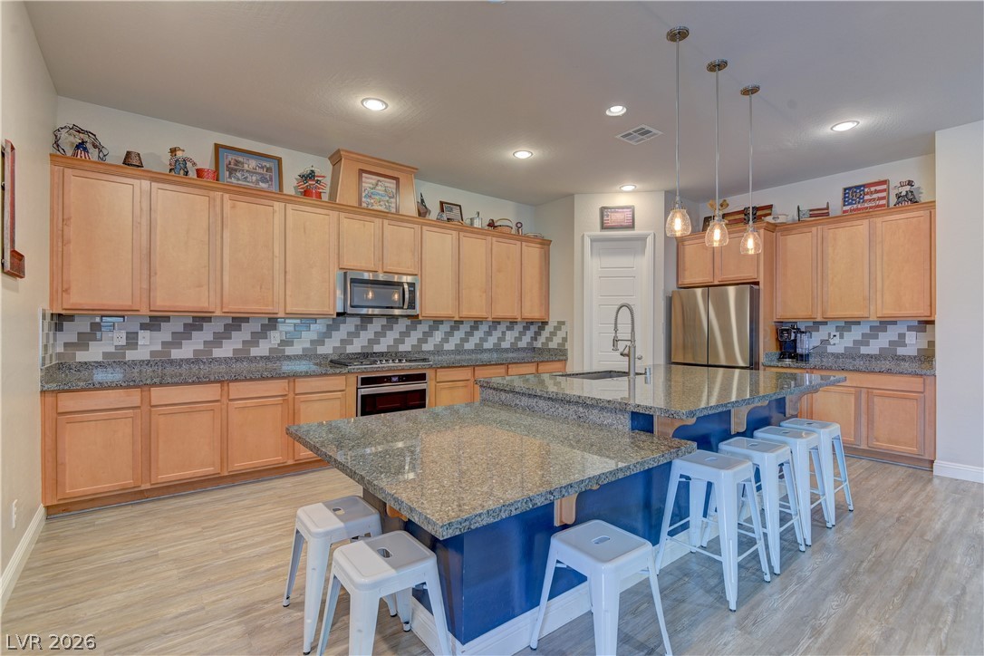 5967 Yellow Ridge Avenue Las Vegas, NV 89131 - Photo 9 of 33 This spacious kitchen offers ample cabinet space and a large island, perfect for entertaining.