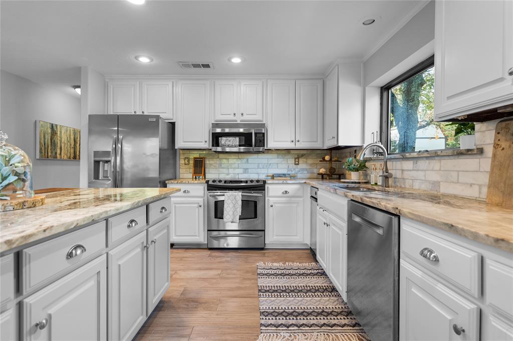 950 Naylor Road Cross Roads, TX 76227 - Photo 15 of 40 a kitchen with granite countertop refrigerator sink and cabinets