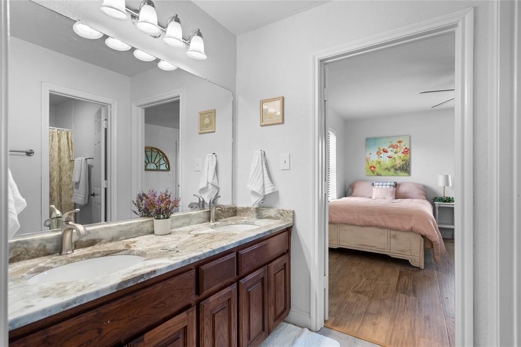 950 Naylor Road Cross Roads, TX 76227 - Photo 23 of 40 a en suite bathroom with a granite countertop sink and a mirror