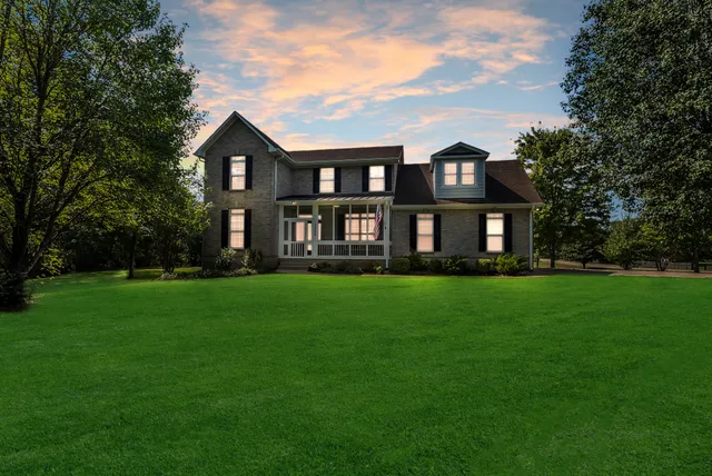 a front view of a house with a garden and porch