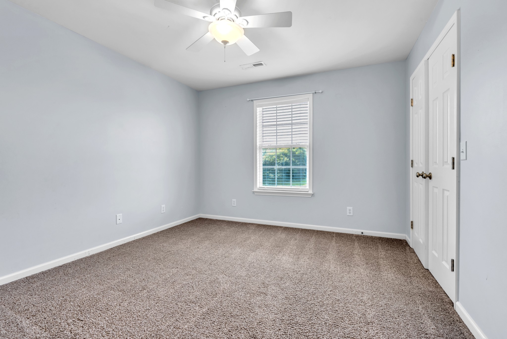 3848 Kedron Road Spring Hill, TN 37174 - Photo 11 of 33 an empty room with a chandelier fan and windows