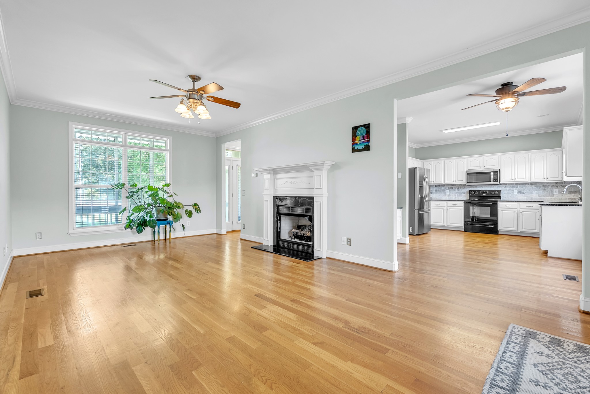 3848 Kedron Road Spring Hill, TN 37174 - Photo 4 of 33 a view of a kitchen with a stove cabinets and wooden floor