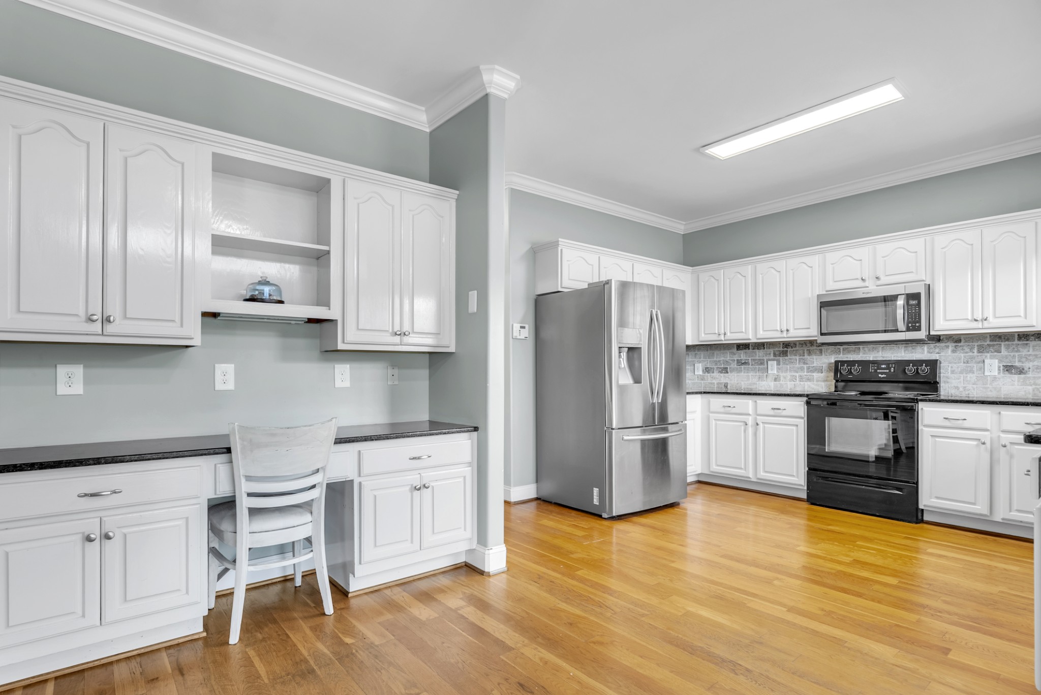 3848 Kedron Road Spring Hill, TN 37174 - Photo 9 of 33 a kitchen with granite countertop white cabinets and stainless steel appliances