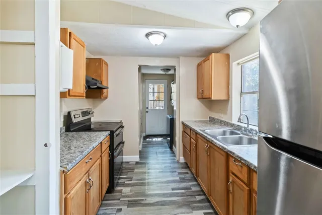 a kitchen with stainless steel appliances granite countertop a stove and a sink