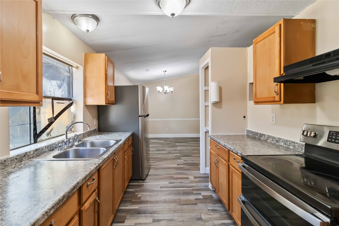 1002 Walter Street Austin, TX 78702 - Photo 12 of 31 a kitchen with stainless steel appliances granite countertop a sink stove and refrigerator