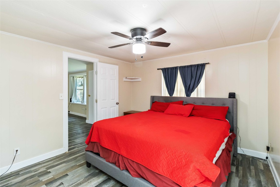 1002 Walter Street Austin, TX 78702 - Photo 16 of 31 a bedroom with a bed and a chandelier
