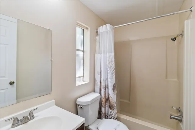 a view of a room with wooden floor and fan