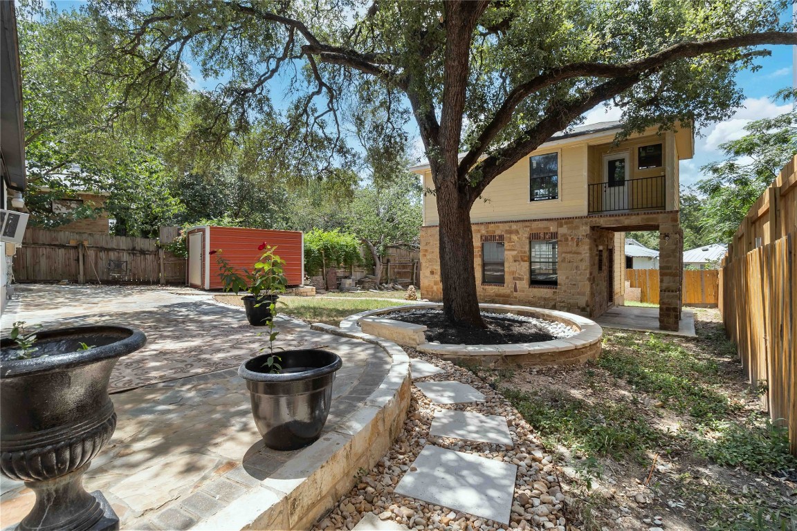 1002 Walter Street Austin, TX 78702 - Photo 6 of 31 a view of a backyard with table and chairs potted plants and large tree