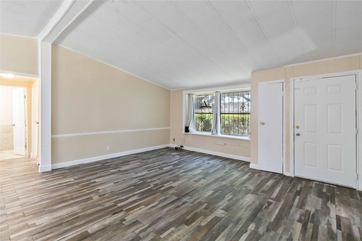1002 Walter Street Austin, TX 78702 - Photo 8 of 31 a view of an empty room with wooden floor and a window