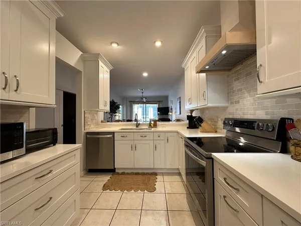 a kitchen with a sink cabinets and stainless steel appliances