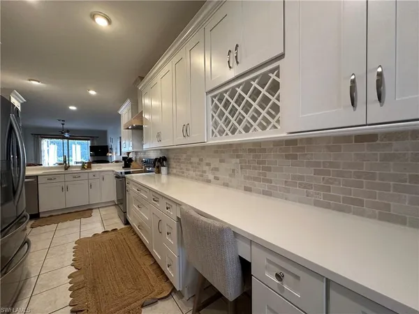a kitchen with cabinets and window