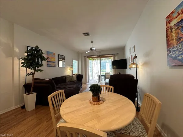 a view of a dining room with furniture and wooden floor