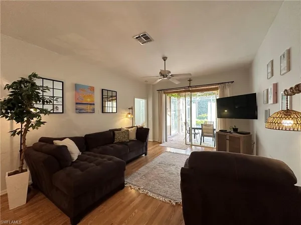 a bedroom with furniture and a flat screen tv