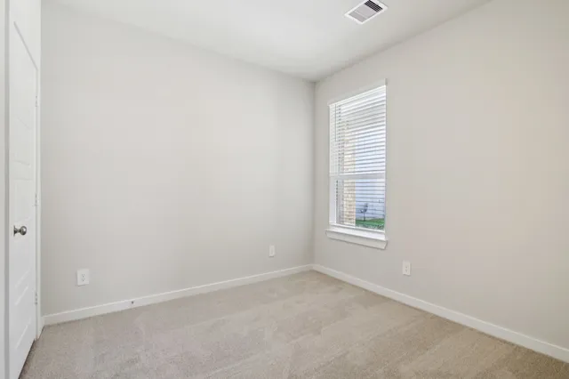 an empty room with closet area