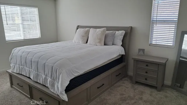 a bedroom with a bed and a dresser