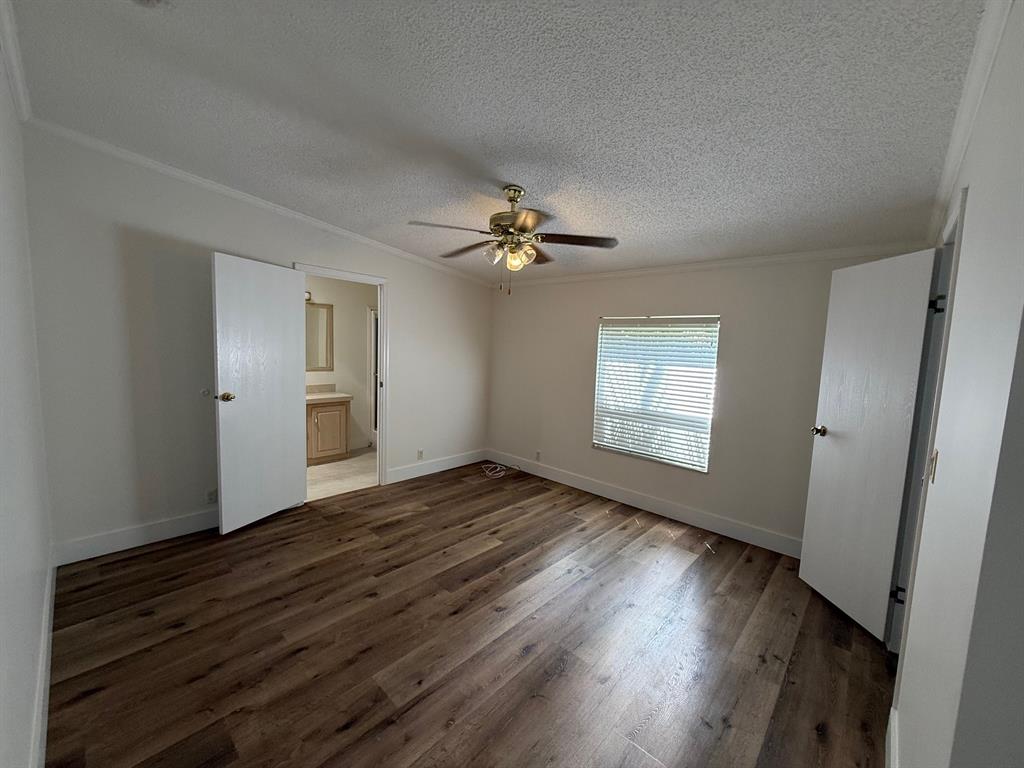 8648 Southwest 16th Place Davie, FL 33324 - Photo 5 of 10 a view of an empty room with wooden floor and a window