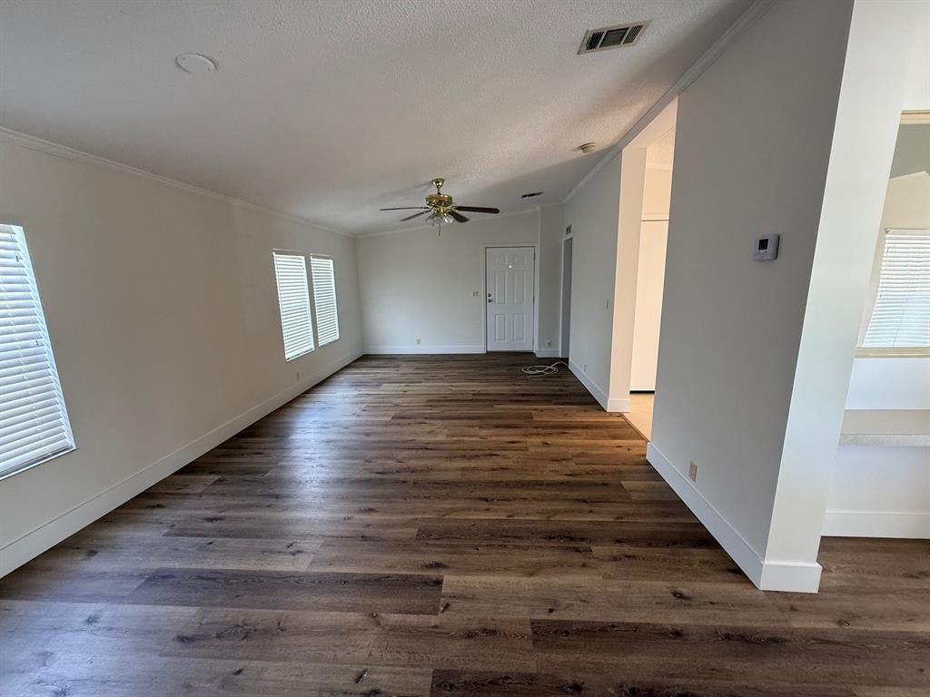 8648 Southwest 16th Place Davie, FL 33324 - Photo 8 of 10 an empty room with wooden floor and windows