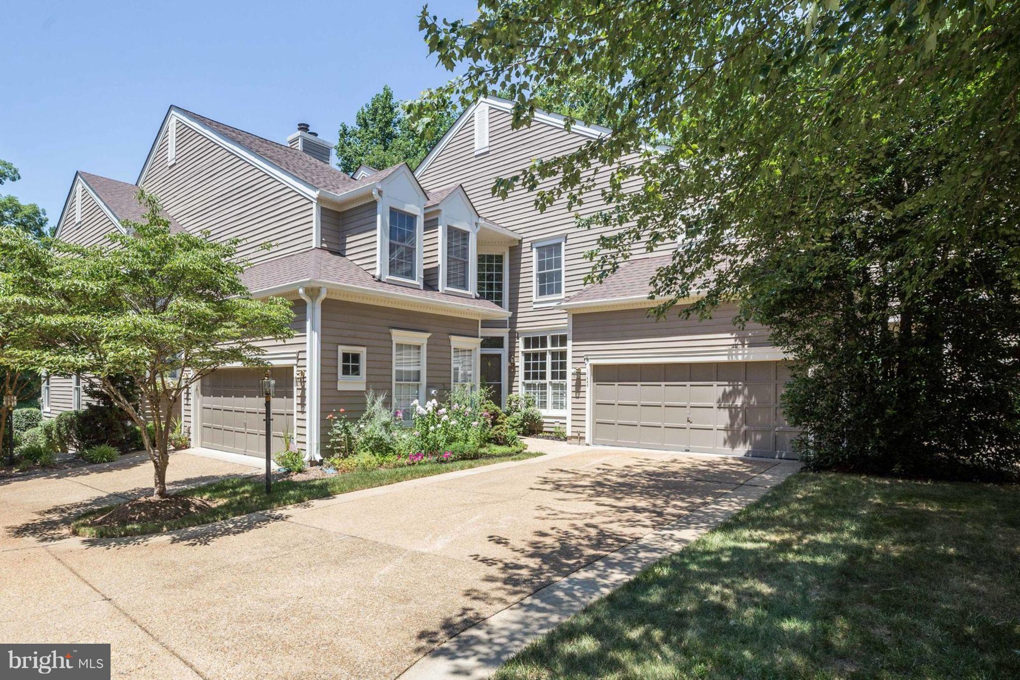 11446 Hollow Timber Court Reston, VA 20194 - Photo 2 of 29 a view of a white house next to a yard with potted plants