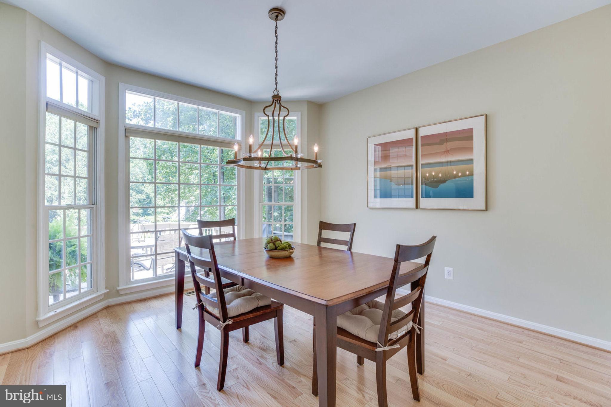 11446 Hollow Timber Court Reston, VA 20194 - Photo 13 of 29 a view of a dining room with furniture wooden floor and chandelier