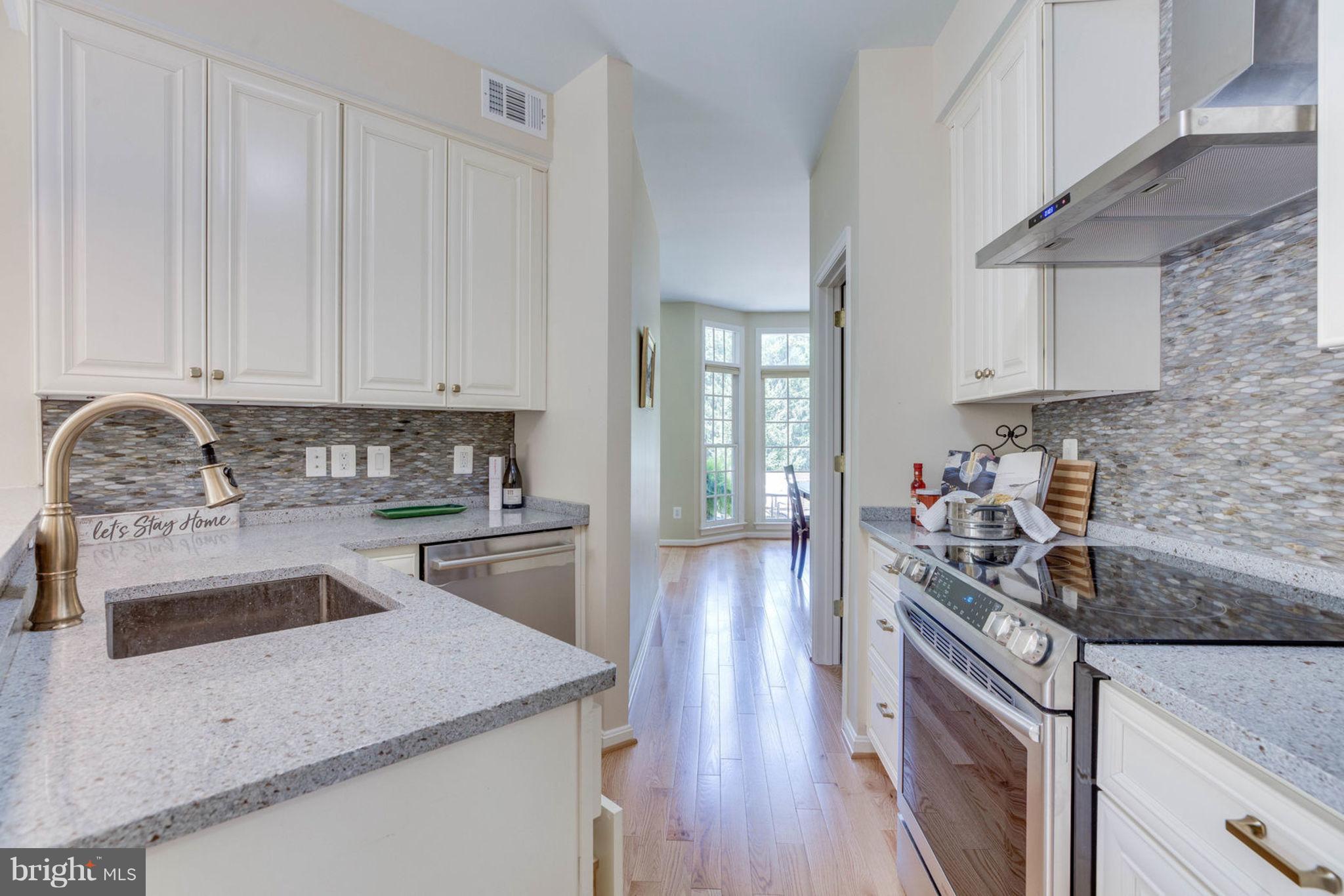 11446 Hollow Timber Court Reston, VA 20194 - Photo 18 of 29 a kitchen with a sink stove top oven and cabinets