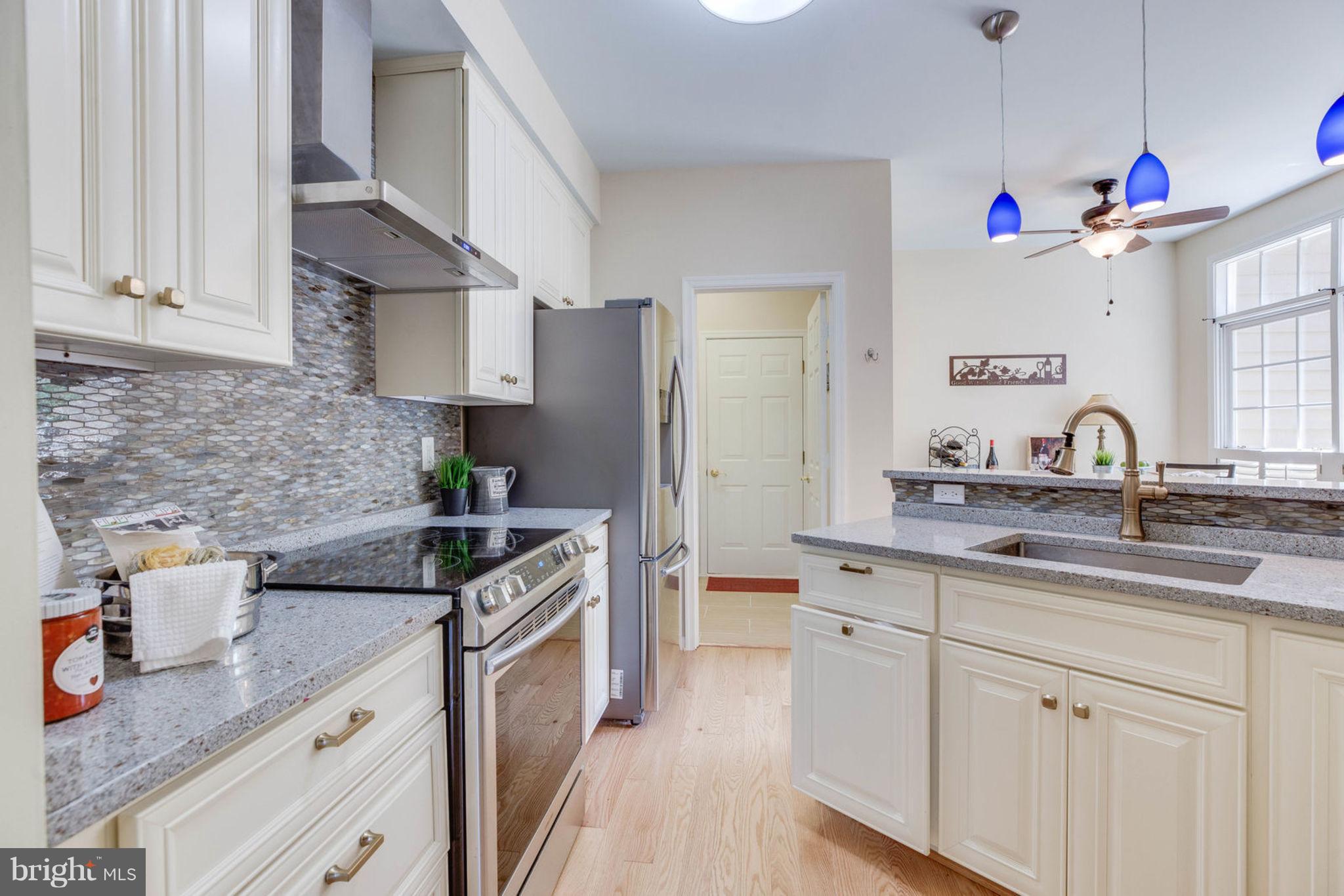 11446 Hollow Timber Court Reston, VA 20194 - Photo 19 of 29 a kitchen with a sink stove top oven and cabinets