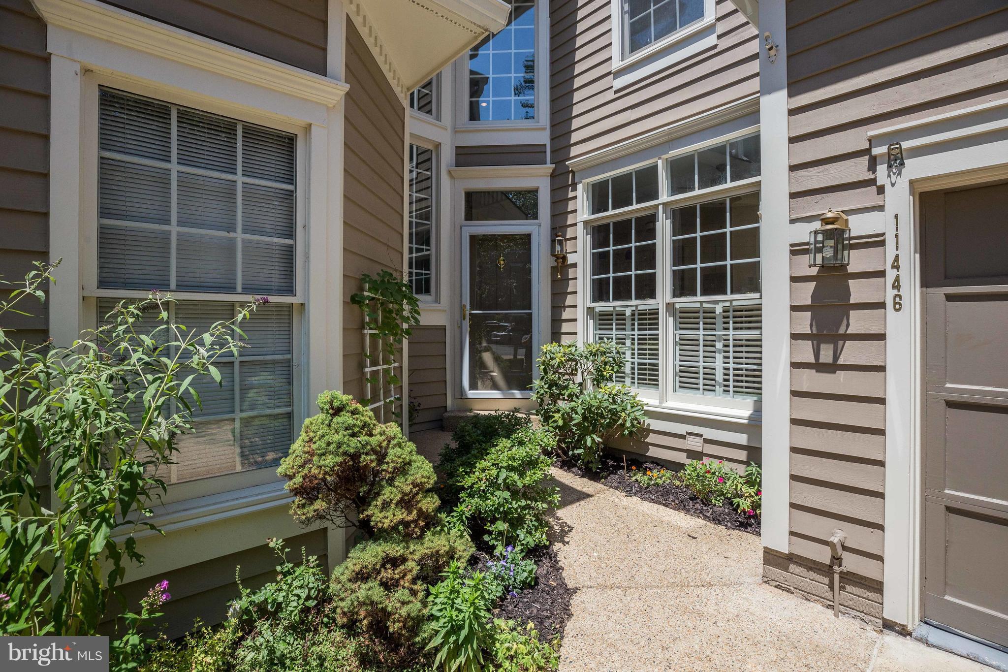 11446 Hollow Timber Court Reston, VA 20194 - Photo 3 of 29 a house with a potted plant in front of door