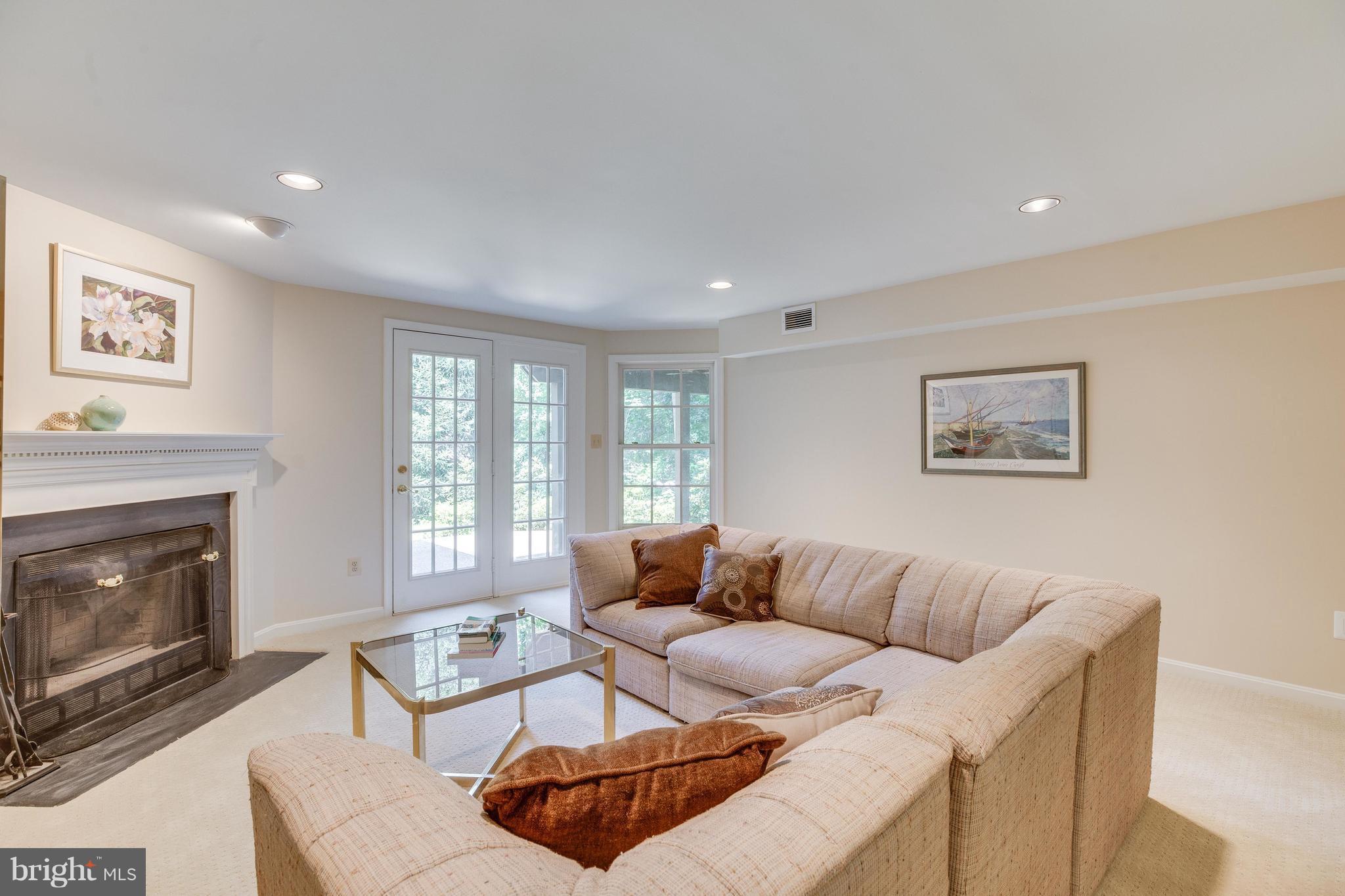 11446 Hollow Timber Court Reston, VA 20194 - Photo 25 of 29 a living room with furniture a fireplace and a large window