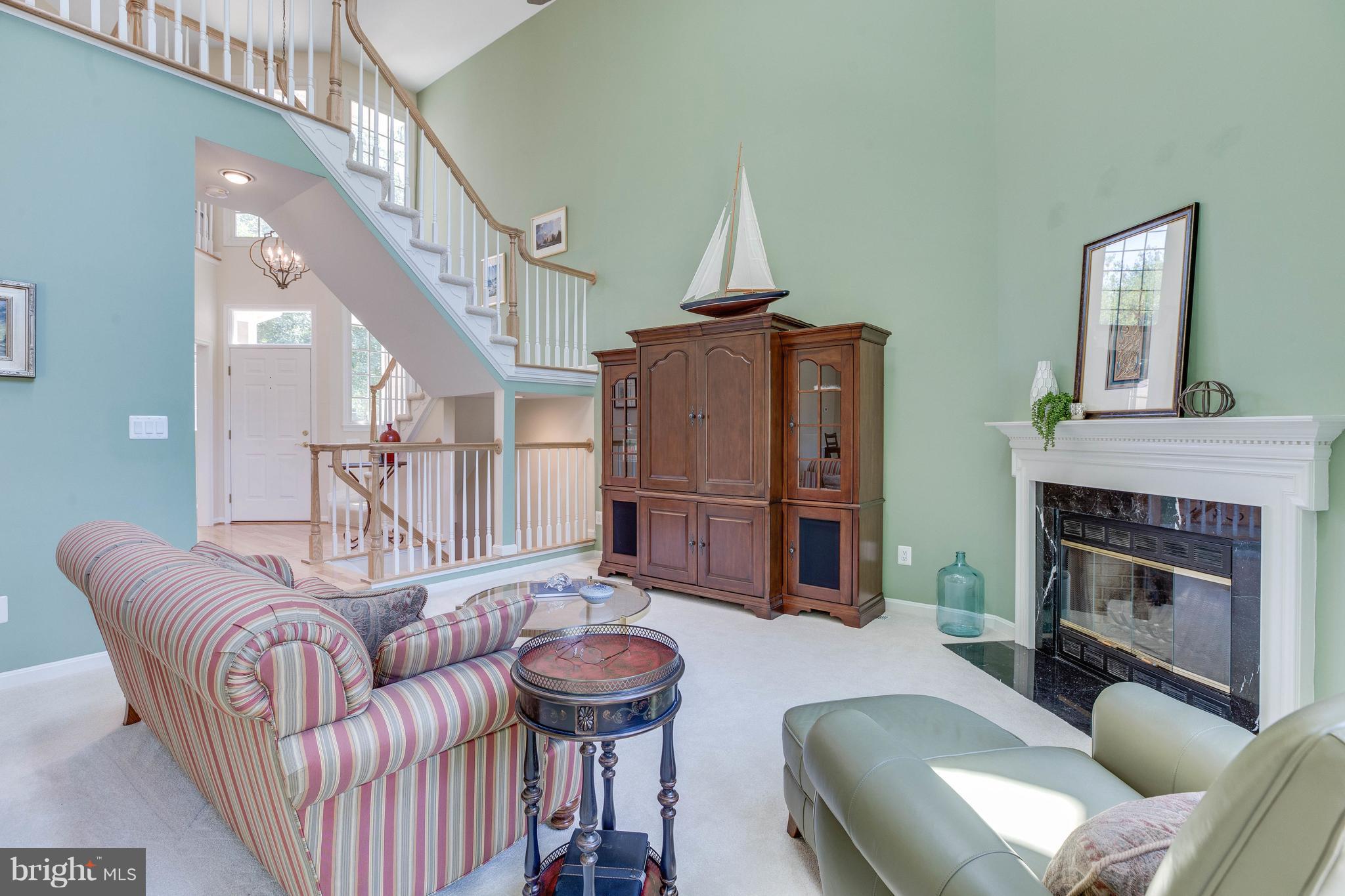 11446 Hollow Timber Court Reston, VA 20194 - Photo 6 of 29 a living room with furniture a fireplace and a chandelier