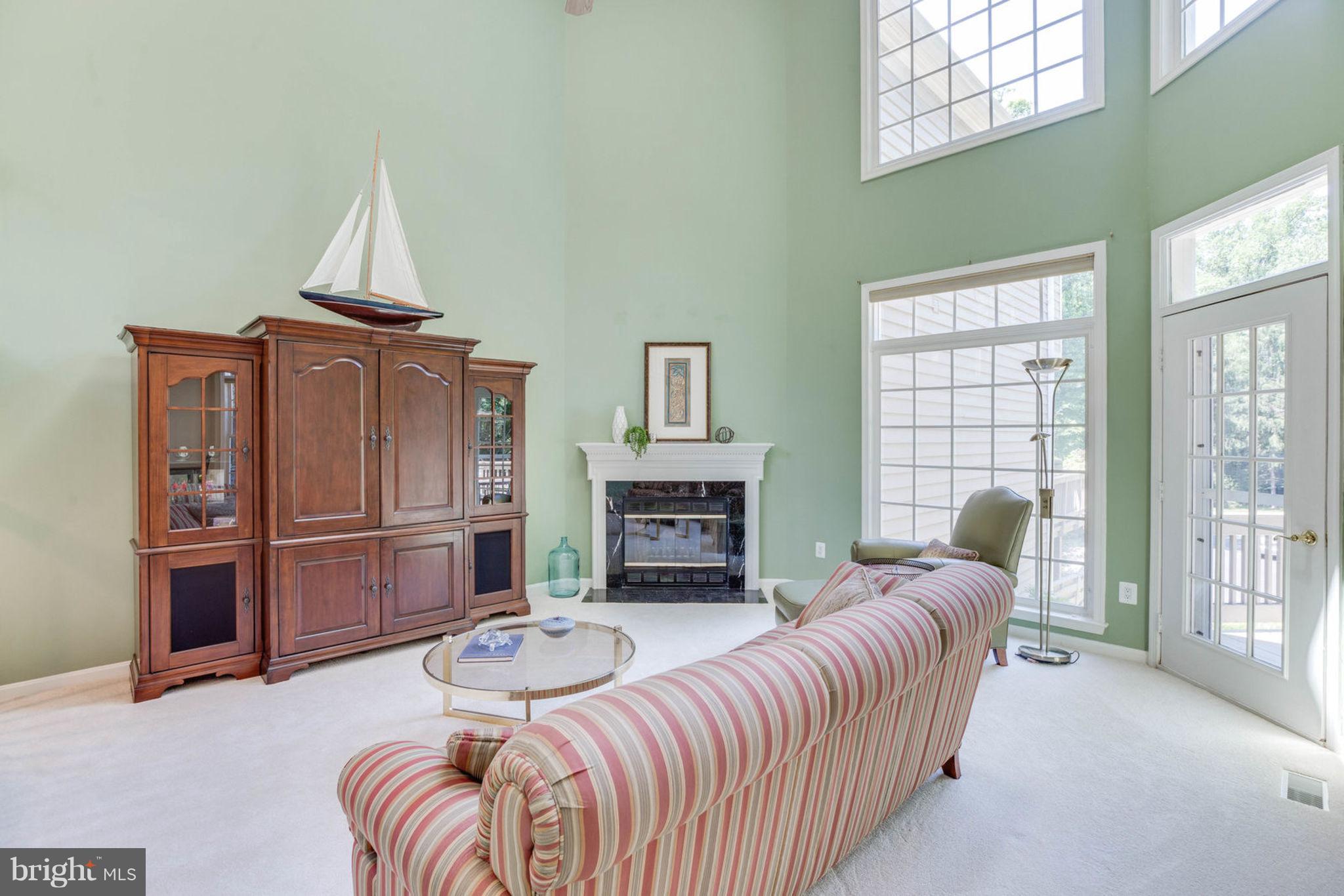 11446 Hollow Timber Court Reston, VA 20194 - Photo 7 of 29 a living room with furniture a fireplace and a large window