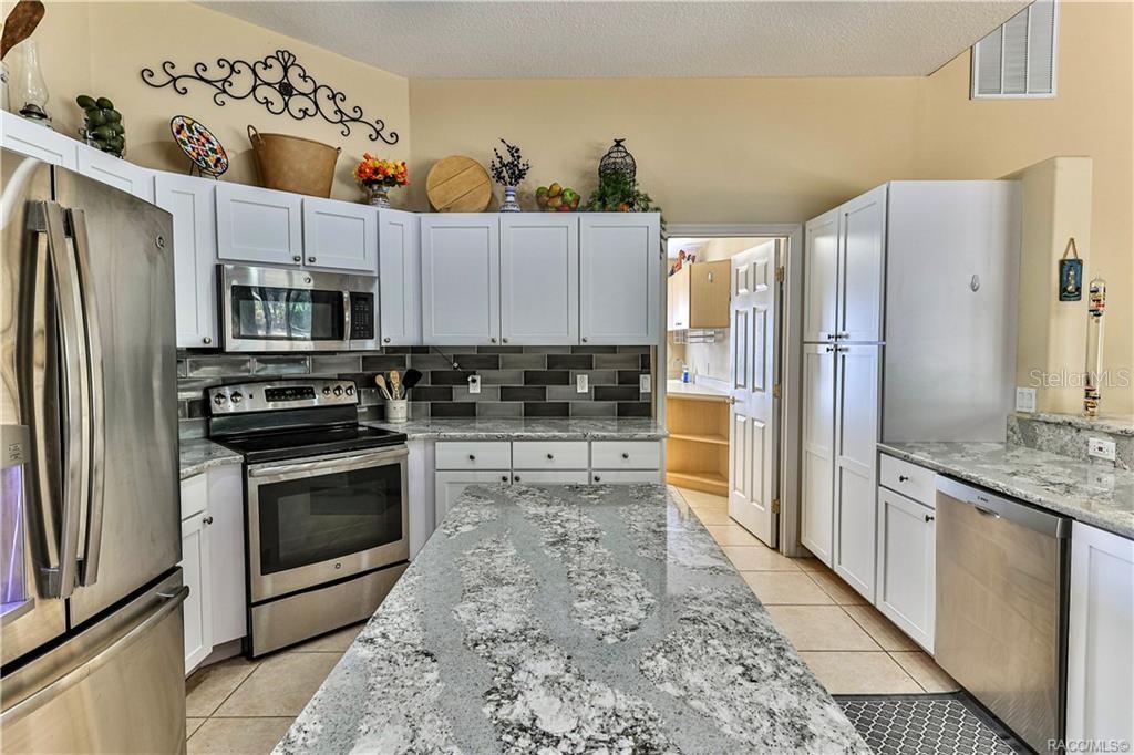 5420 North Rosedale Circle Beverly Hills, FL 34465 - Photo 11 of 49 a kitchen with stainless steel appliances granite countertop a refrigerator stove and sink