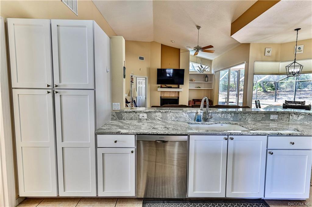 5420 North Rosedale Circle Beverly Hills, FL 34465 - Photo 16 of 49 a kitchen with stainless steel appliances granite countertop a refrigerator a sink and white cabinets