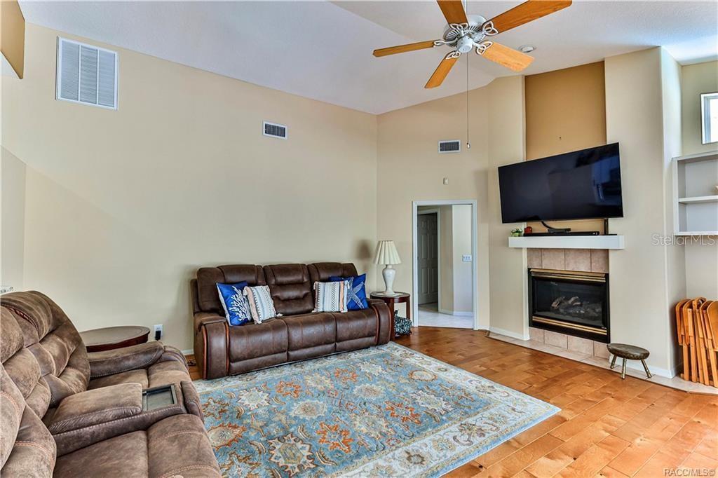 5420 North Rosedale Circle Beverly Hills, FL 34465 - Photo 20 of 49 a living room with furniture a flat screen tv and a fireplace
