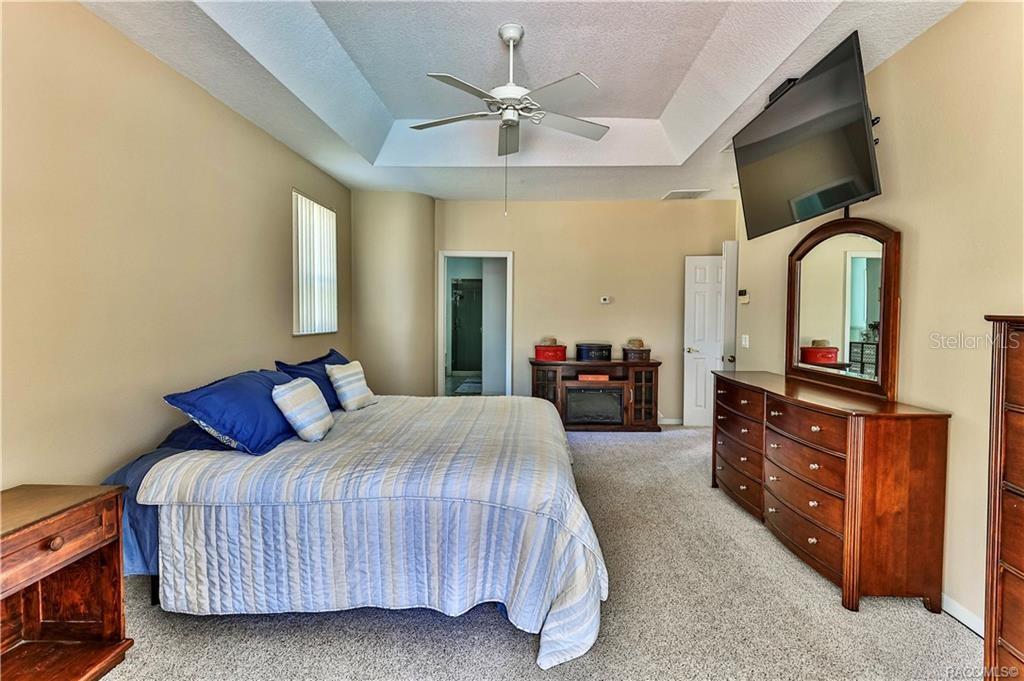 5420 North Rosedale Circle Beverly Hills, FL 34465 - Photo 21 of 49 a bedroom with a bed and a flat screen tv